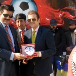 Mr. Nassir Kasuri Executive Director BeaconHouse (BSS) presenting shield to Dr Shahzad Waseem — at Pakistan Sports Complex.