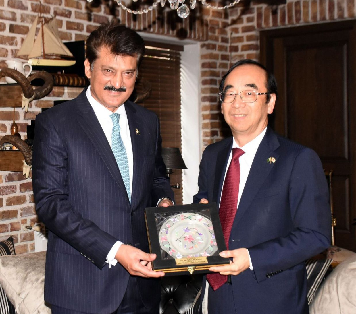 Senator Dr. Shahzad Waseem presenting a commemorative shield to outgoing Japanese Ambassador H.E Wada Mitsuhiro.
